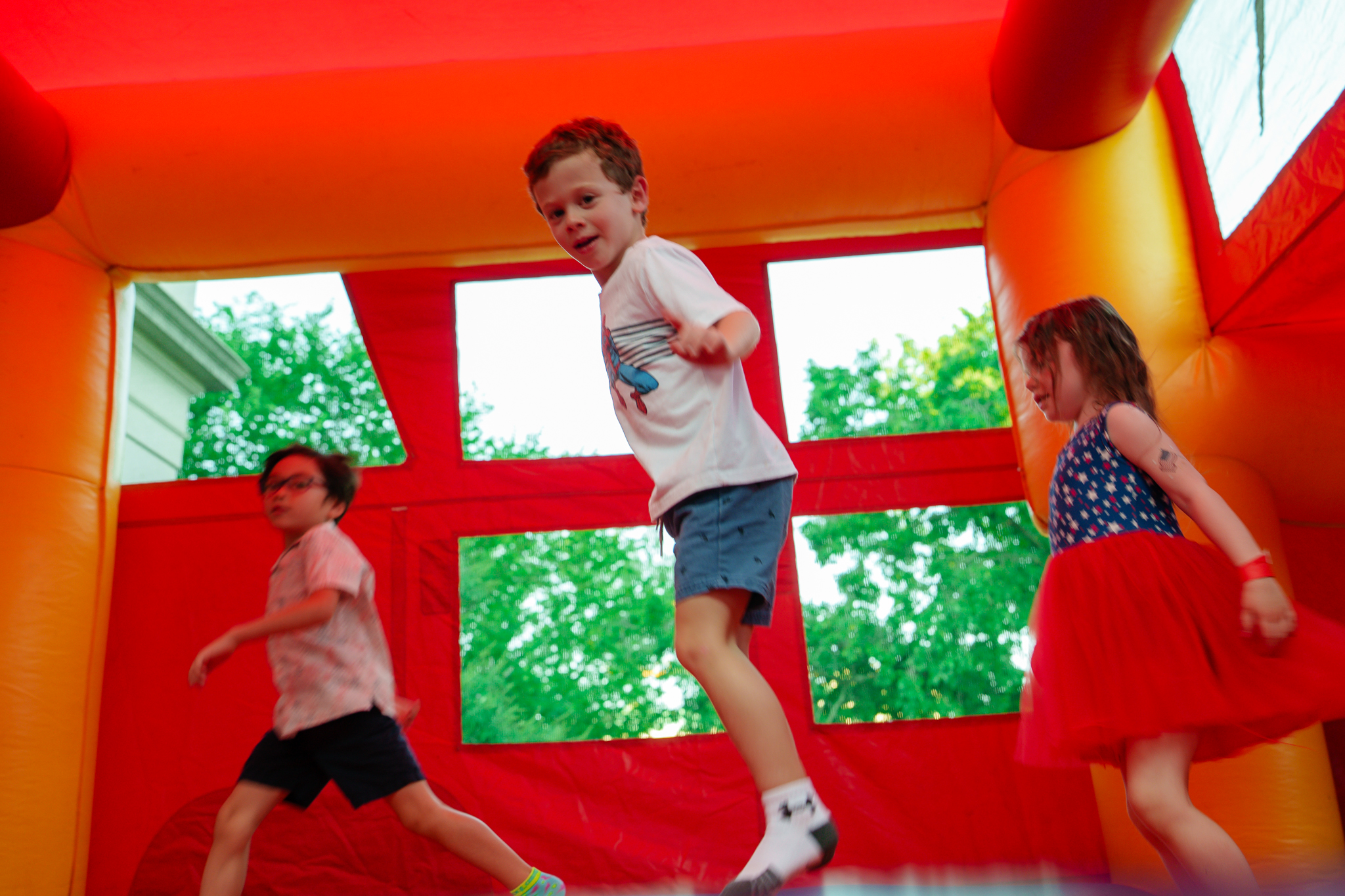 Children bounce in a bouncy house