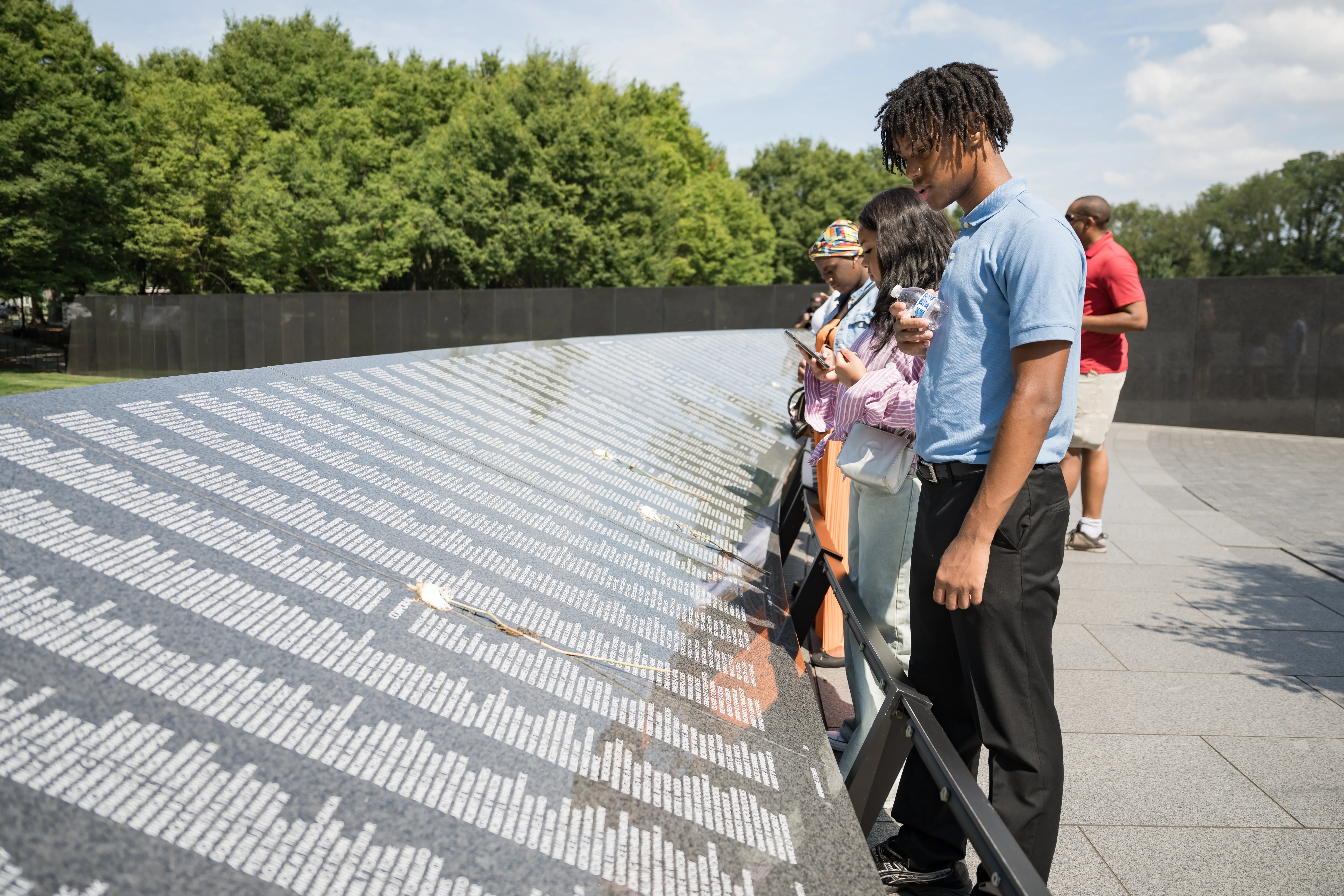 A young Black man looks at the Korean War Memorial in Washington DC