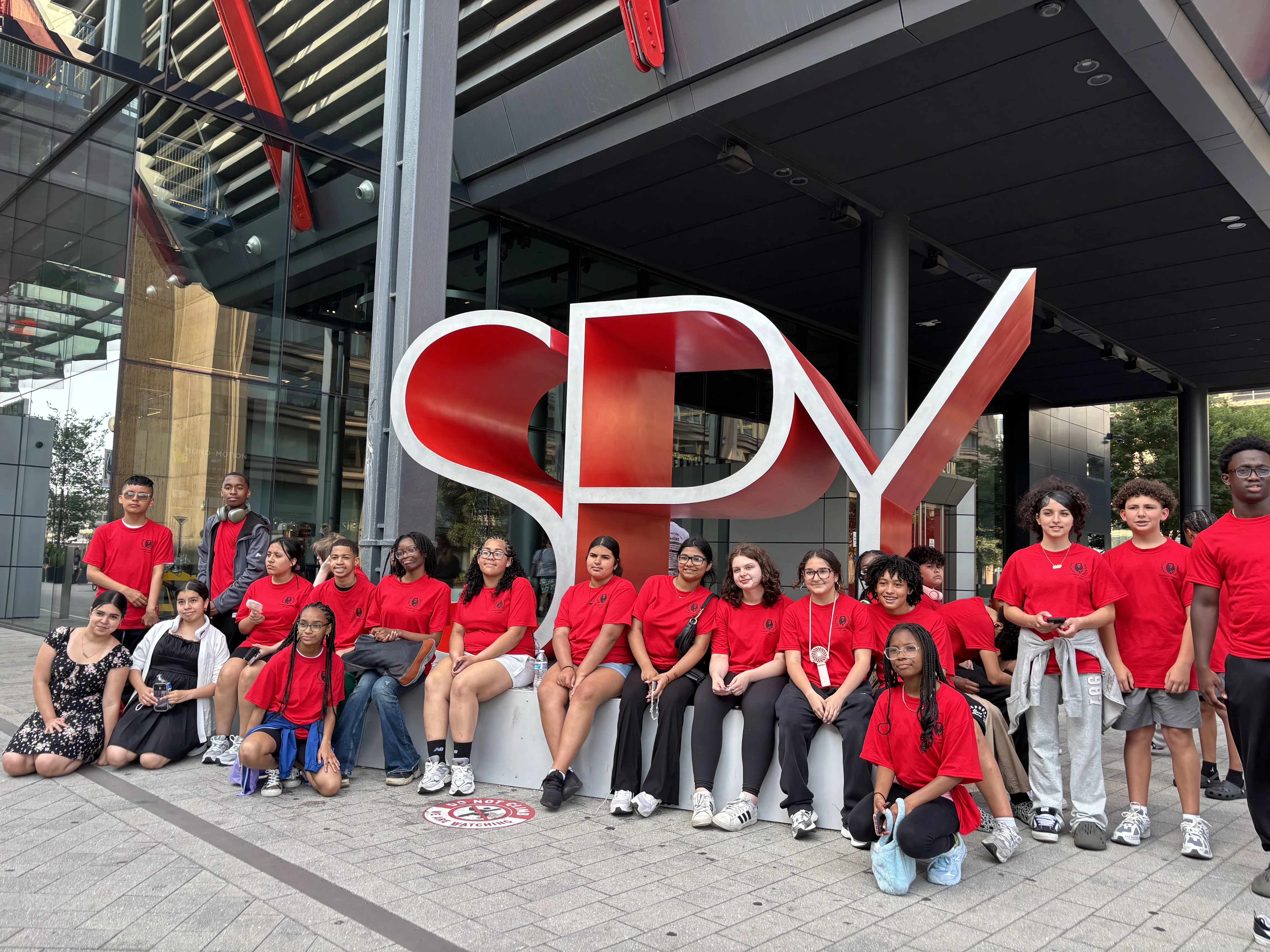 Students stand in front of the International Spy Museum