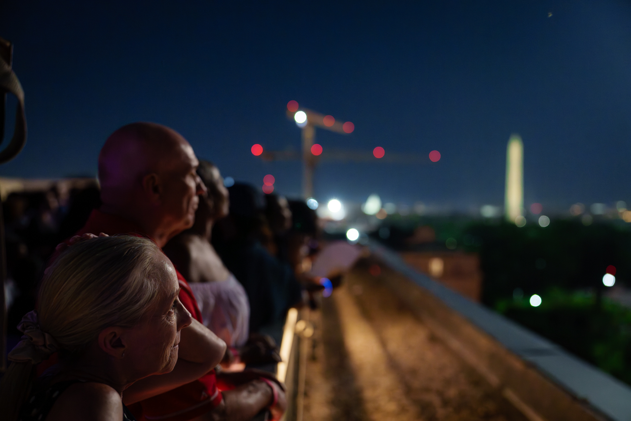 Guests watch the fireworks from the roof of the APhA building