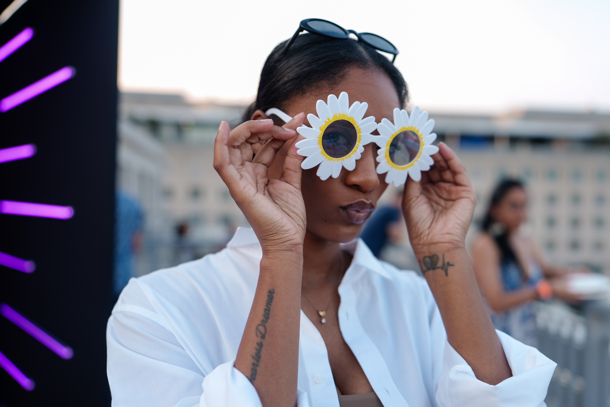 A young woman with flower sunglasses