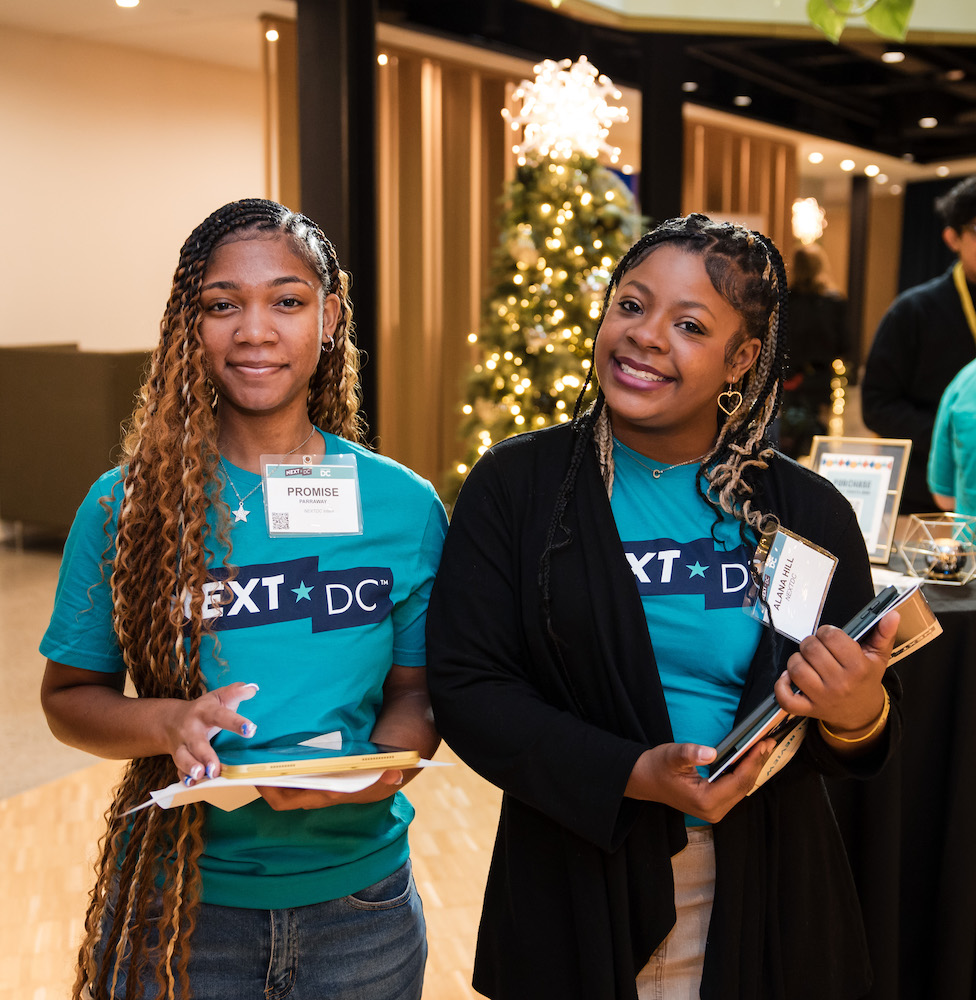 Promise and Alana, two NEXTDC interns, show off the Annual Review