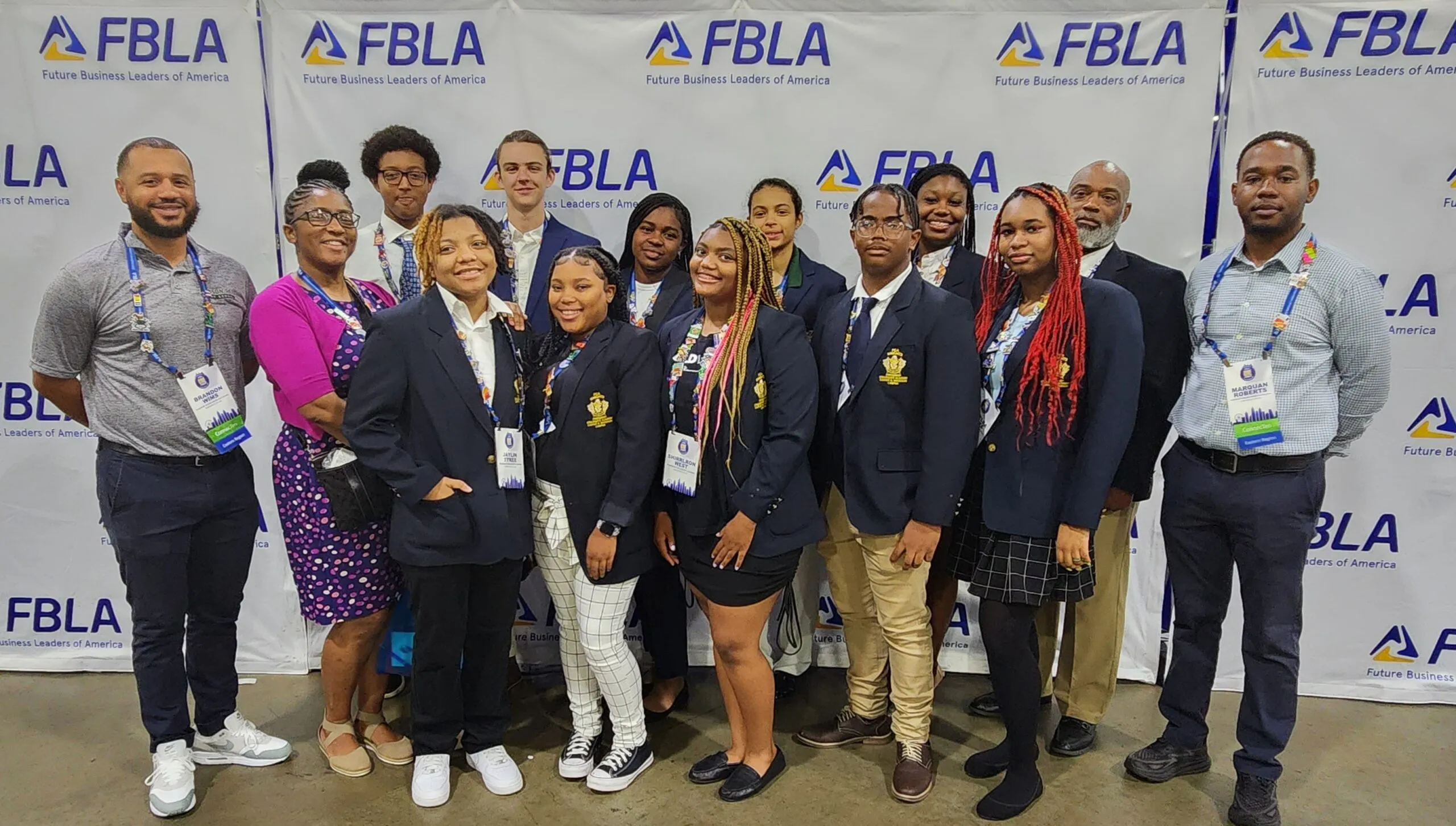 A group of Black teenagers - the DC FLBA team - pose for a photo